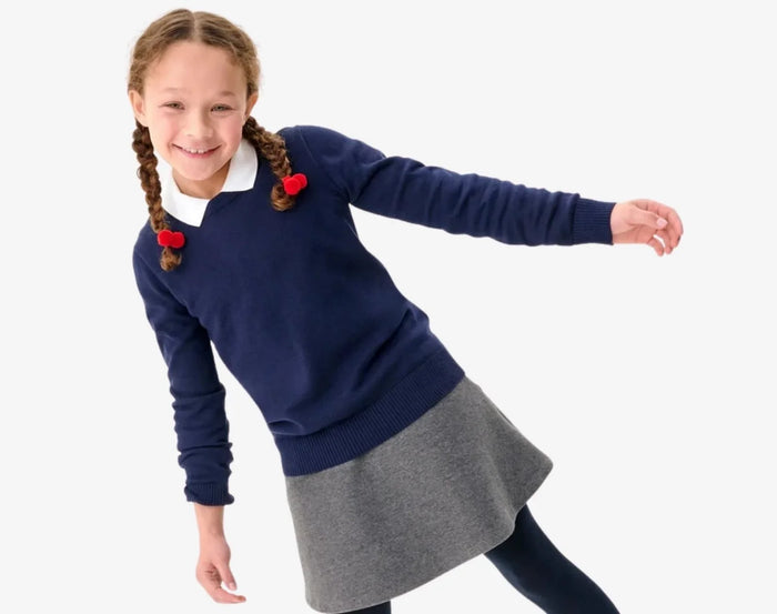 Girl in uniform wearing Primary French Terry Sweater - Navy. Available at www.tenlittle.com