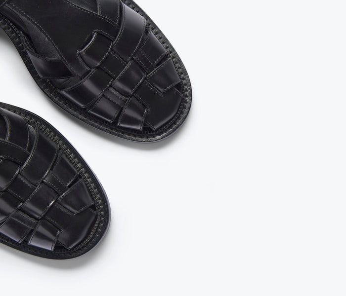 Black Dahlia T-strap fisherman loafer by Freda Salvador with sleek design and detailed stitching on the leather shoe.