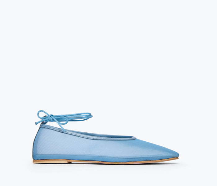 Fredas Salvador Daisy Mesh Flat in denim with a mesh upper, showcasing a stylish, flat shoe design with a rounded toe.
