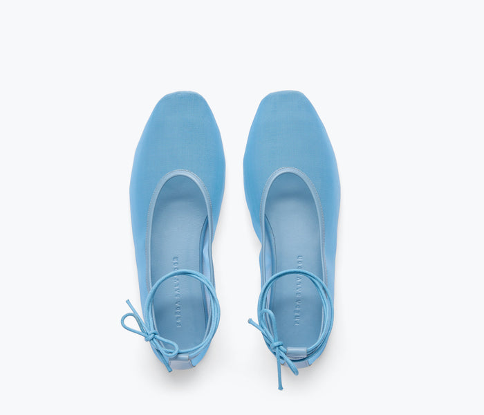 Fredas Salvador Daisy Mesh Flat featuring denim and mesh materials, showcasing a sleek, flat shoe design with detailed stitching.