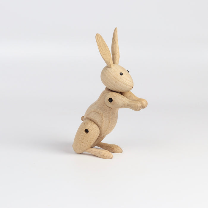 Side view of Kay Bojesen Wood Rabbit on white background.