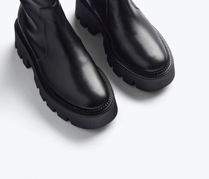 FREDA SALVADOR Darla black lug sole Chelsea boot with sleek leather design and pull tabs on the sides.