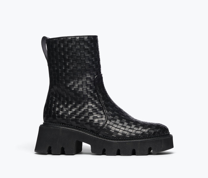 Black woven Chelsea boot by Freda Salvador featuring a sleek silhouette and elastic side panels, front view.