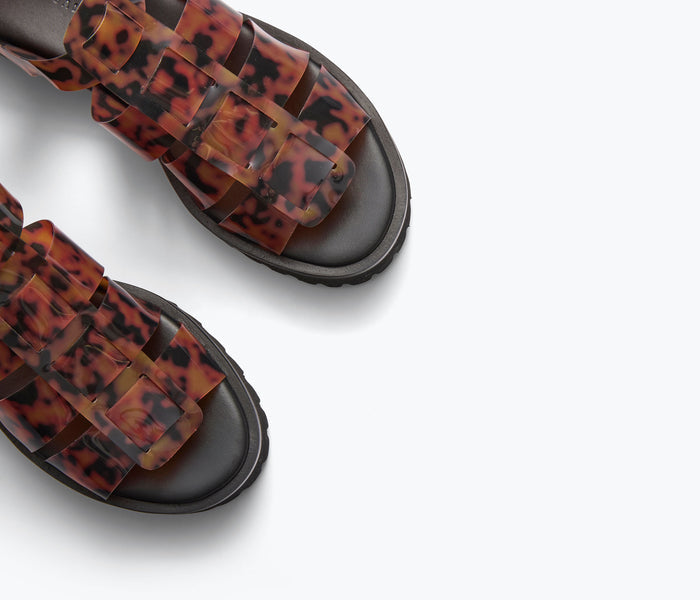 Freda Salvador Darya Lug Sole Fisherman sandal in turquoise PVC with detailed strap design.