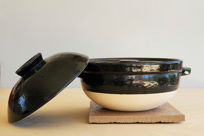 Donabe with lid on side. Made in Japan.