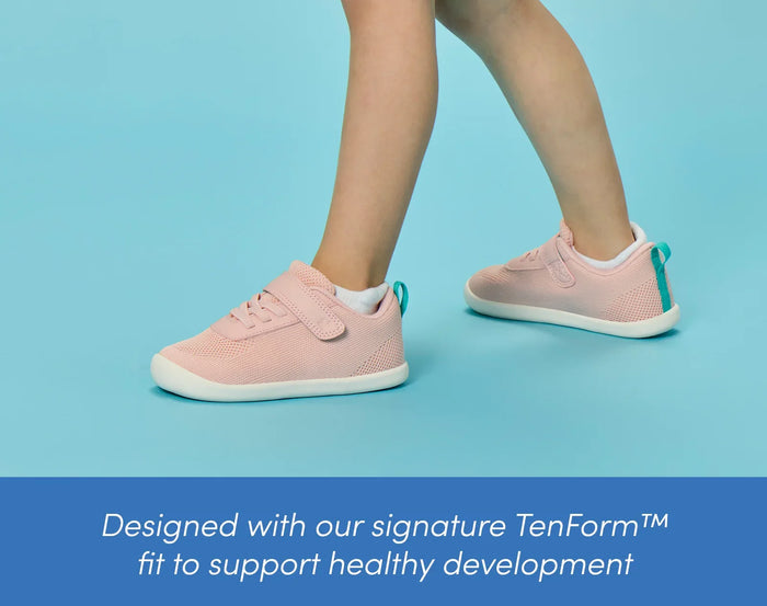 Side view child wearing Ten Little DuoKnit Sneakers designed with our signature TenForm™ fit to support healthy development - Powder Pink. Available at www.tenlittle.com