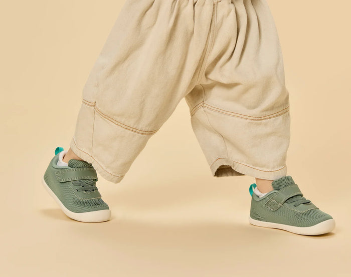 Side view child wearing Ten Little DuoKnit Sneakers - Agave Green. Available at www.tenlittle.com