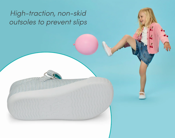 Split view of non-slip rubber outsole to prevent slips and child playing with balloon wearing Ten Little Eco Canvas Mary Janes - Blue Seersucker, Pink Seersucker. Available at www.tenlittle.com