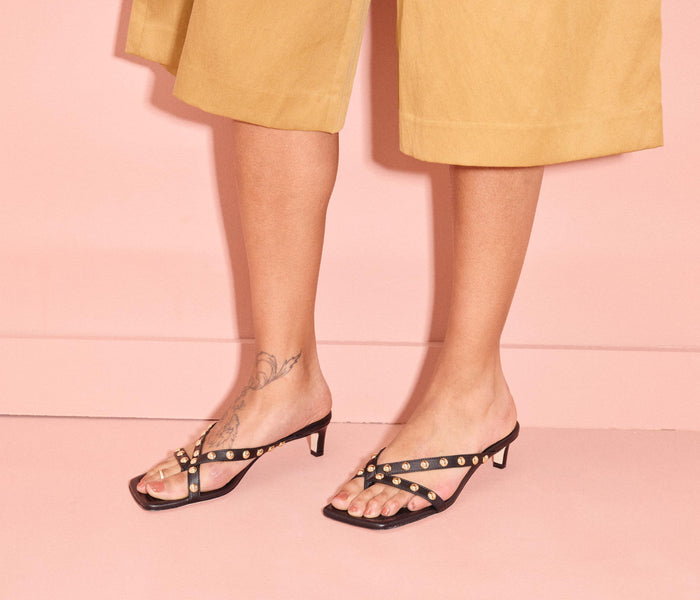 Black and gold FREDA SALVADOR ELAINE heel shoe with stylish design and pointed toe, perfect for elegant footwear.