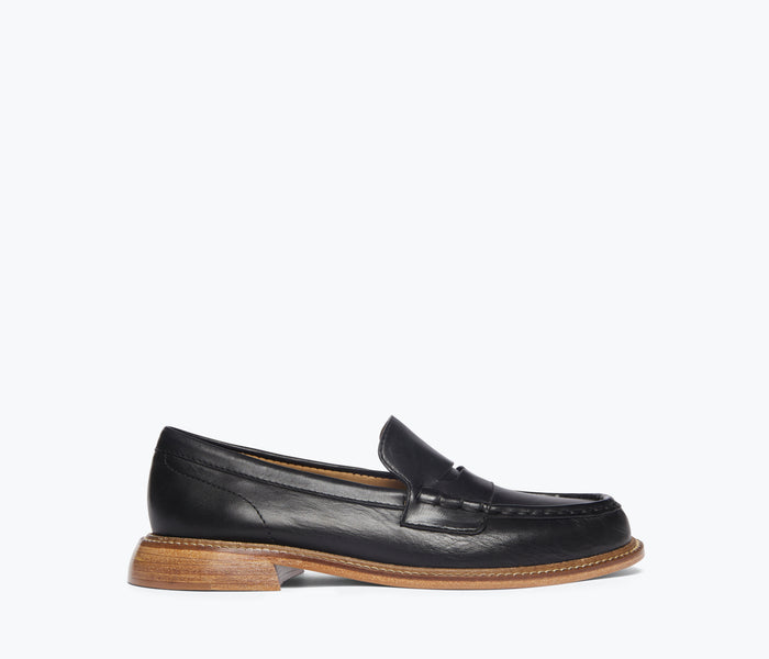 Freda Salvador Elba penny loafer in black leather with gold hardware, showcasing a classic slip-on design and sleek craftsmanship.