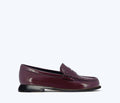 Freda Salvador Elba Penny Loafer in plum spazzolato leather, front view showing sleek design and polished finish.