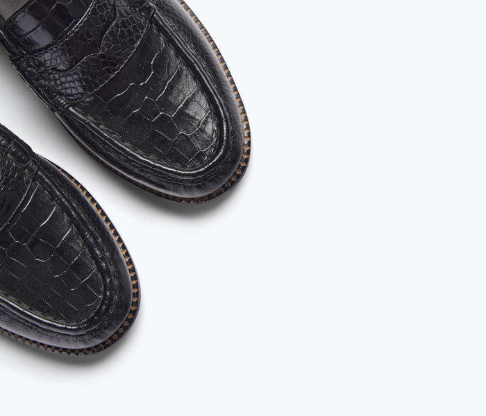 Black FREDA SALVADOR Elba Penny Loafer with crocodile-embossed leather detail, showcasing classic slip-on style and refined craftsmanship.
