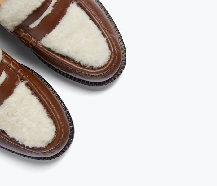 Freda Salvador Elba penny loafer in cognac leather with shearling detail, showing a close-up of the stylish slip-on footwear.