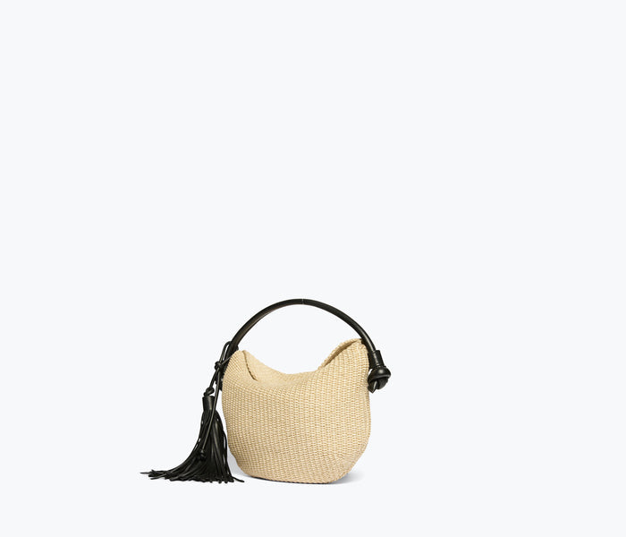 Freda Salvador Elis Mini Crescent Bag in natural raffia, side view showing compact, stylish bag with a curved silhouette and woven texture.