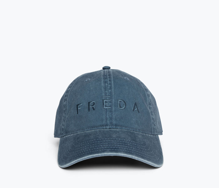 Blue embroidered Freda hat by OTTO with detailed front view, showcasing stylish apparel design and craftsmanship.