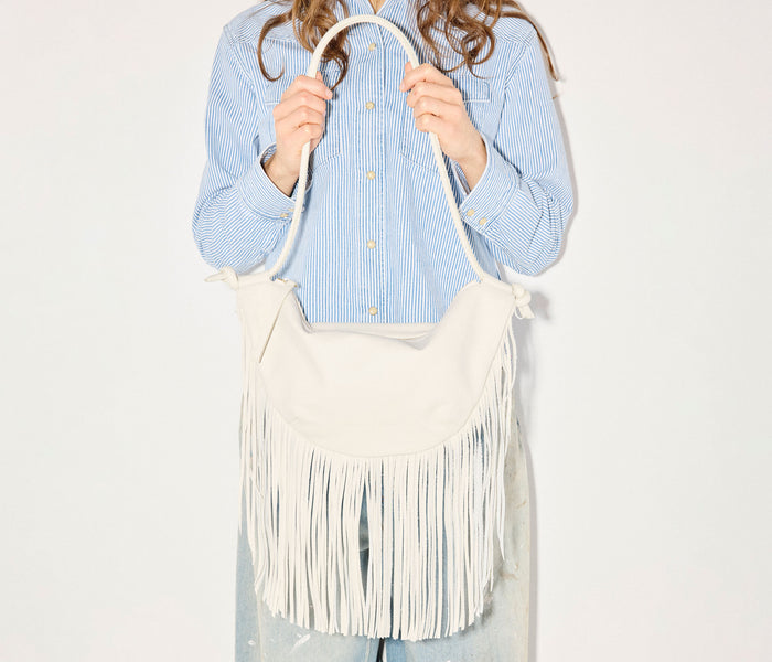 Freda Salvador Erika Crescent Fringe Bag in bone calf leather, stylish handbag with fringe detailing and crescent shape.