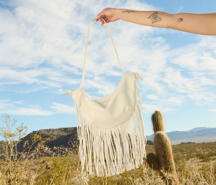 Freda Salvador Erika Crescent Fringe Bag in bone calf leather with fringe details, stylish handbag with shoulder strap.