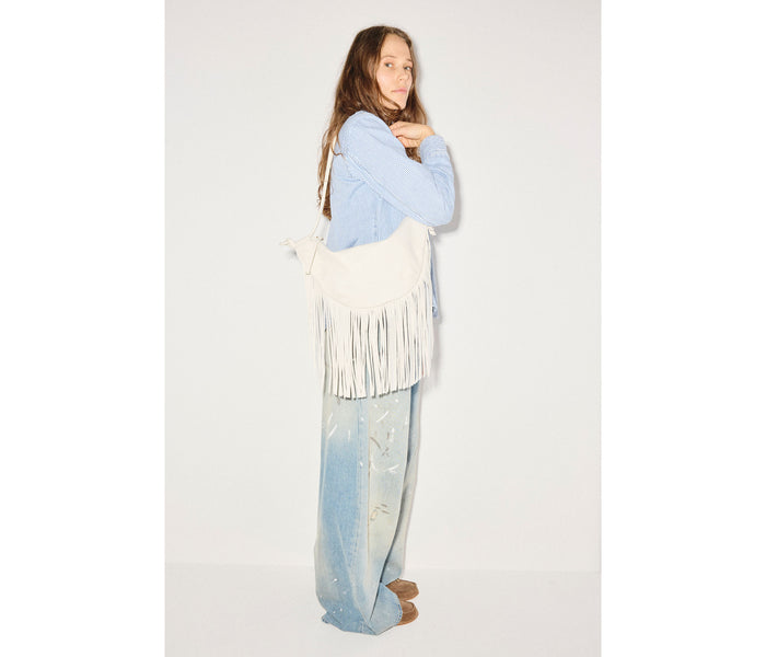 Freda Salvador Erika Crescent Fringe Bag in bone calf leather, showcasing a stylish handbag with fringe detailing and a crescent shape.