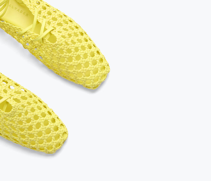 Yellow woven ankle lace-up mule by Freda Salvador with calf strap detail.