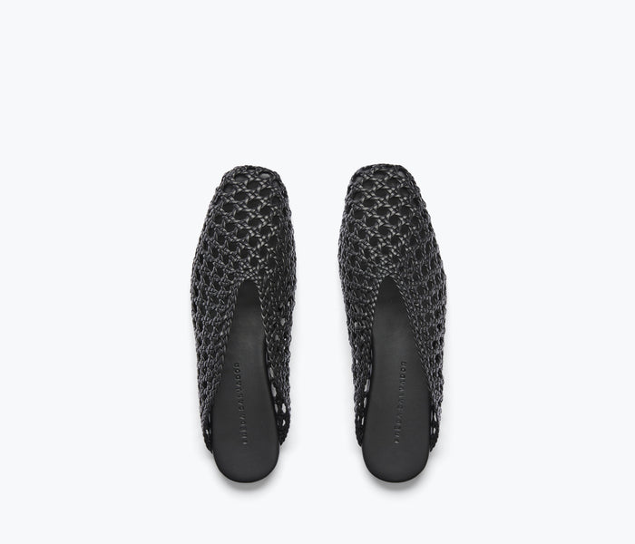 Black woven ankle lace-up mule by Freda Salvador with a sleek flat design and woven calf top detail.
