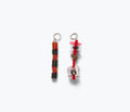Red beaded lace totem charm accessory by Don't Let Disco with intricate beadwork and unique design.