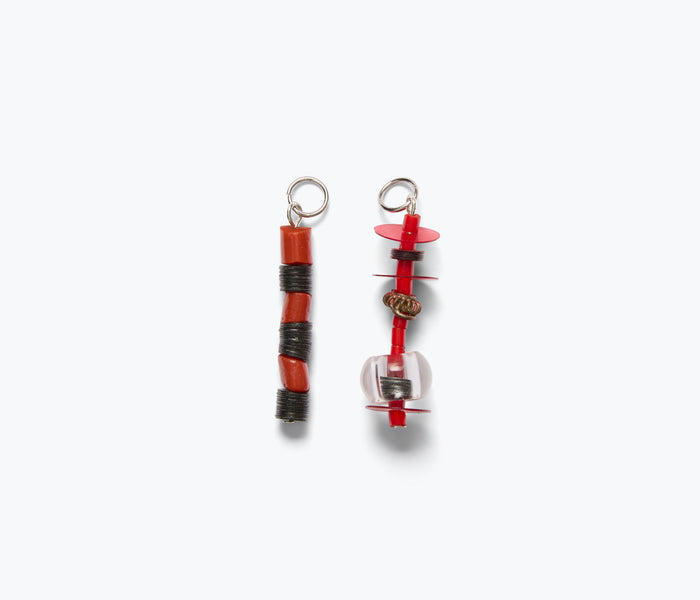 Red beaded lace totem charm accessory by Don't Let Disco with intricate beadwork and unique design.
