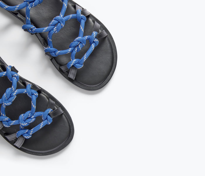 Close-up of Freda Salvador FAE Rope Sandal in cobalt blue, showing woven rope strap and sleek sandal design.