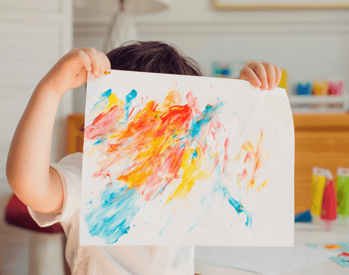 Child holding up painting using Djeco Finger Paint Tubes - Set of 6. Available at www.tenlittle.com