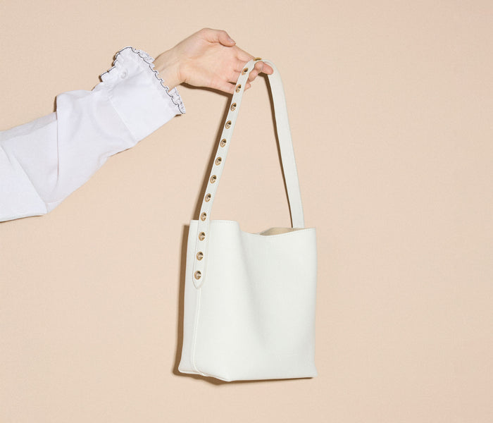 Freda Salvador Fiona Small Studded Tote bag in bone calf leather with metal stud details, stylish and compact handbag.