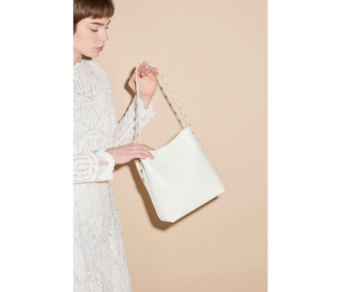 FREDA SALVADOR Fiona small studded tote bag in bone calf leather, featuring metal stud accents and compact design.