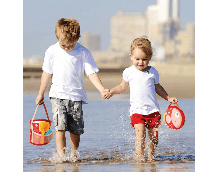 Kids at beach using Hape Fold and Go Beach Set. Available at www.tenlittle.com