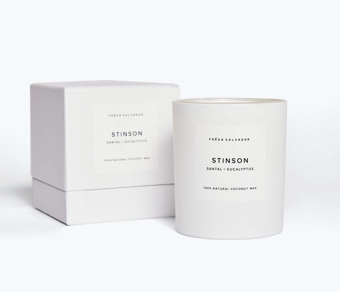 White FRĒDA Candle in elegant packaging by FREDA SALVADOR, showcasing a sleek, minimalist design with clean lines.