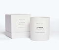 White FRĒDA Candle in elegant packaging by FREDA SALVADOR, showcasing a sleek, minimalist design with clean lines.