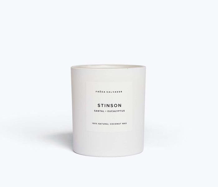 White FRĒDA Candle by FREDA SALVADOR with a sleek, minimalist design, shown from the front.