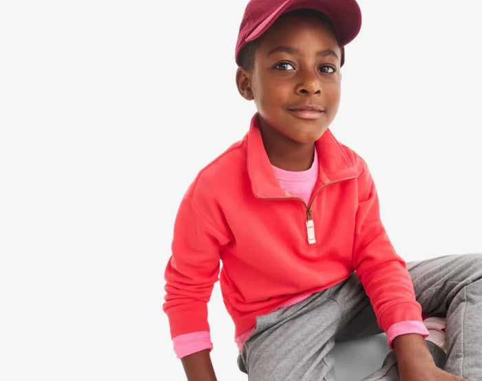Boy wearing Primary French Terry Quarter Zip Sweatshirt - Strawberry. Available at www.tenlittle.com