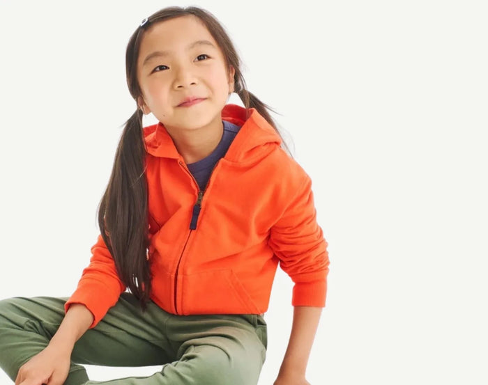 Child wearing Primary French Terry Zip Hoodie - Orange. Available at www.tenlittle.com