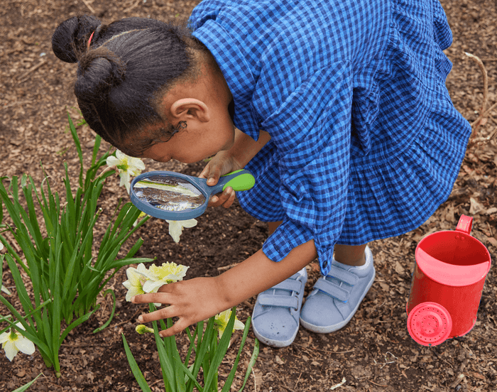 Child using Beetle & Bee Garden Watering Can - Red. Available at www.tenlittle.com