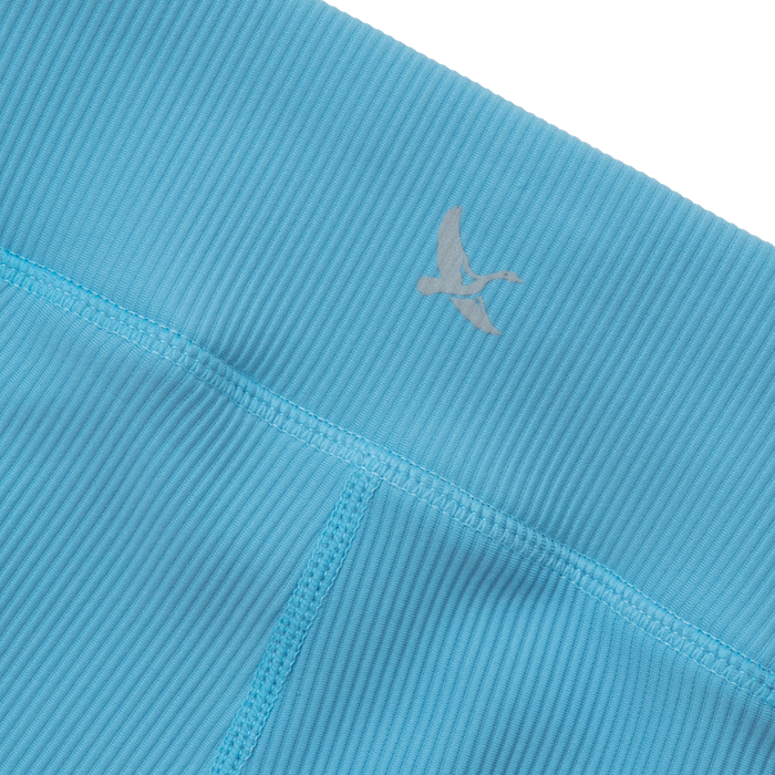 Turquoise ribbed leggings with vertical texture and a gray logo on the waistband.