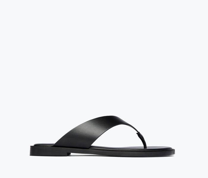 Freda Salvador Halle leather thong sandal in black, featuring a sleek front view with minimalist design and smooth calf leather straps.