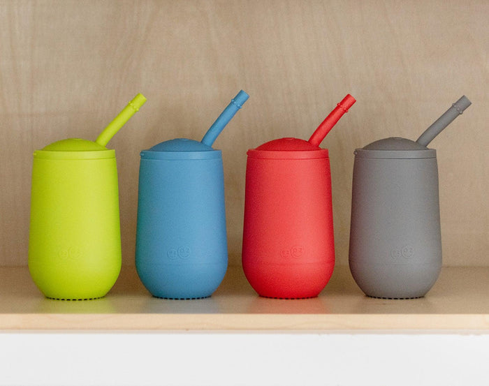 ezpz Happy Cup & Straw in blue and 3 other colors inside cabinet. Available at tenlittle.com