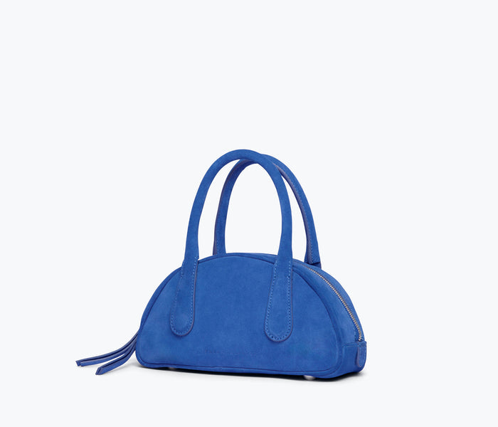 Freda Salvador Harlow Mini Bowling Bag in cobalt blue suede with side detail and compact design.