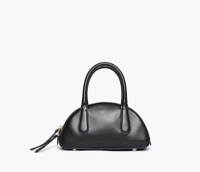 Black calf leather Harlow mini bowling bag by Freda Salvador showing the front view with rounded shape and top handle.