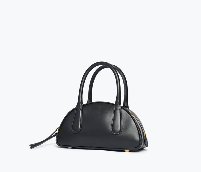 Fred Saldor Harlow Mini Bowling Bag in black calf leather, side view showing compact design and sleek style.