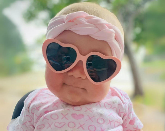 Baby wearing Ten Little Roshambo Heart Sunglasses - Pink. Available at www.tenlittle.com