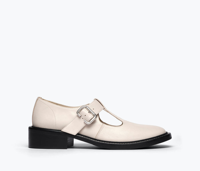 Freda Salvador Helen T-strap loafer in powder white pebbled calf leather, front view showing stylish T-strap design.