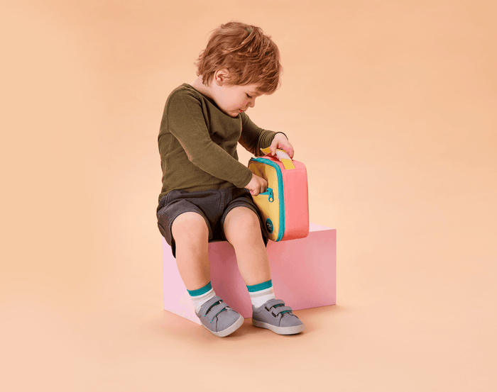 Boy using Ten Little Insulated Recycled Lunch Box - Pink & Yellow. Available at www.tenlittle.com