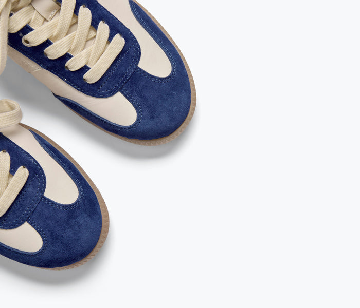 FREDA SALVADOR Jackie sneaker in cobalt blue suede with white sole and lace-up design, close-up view of stylish casual footwear.