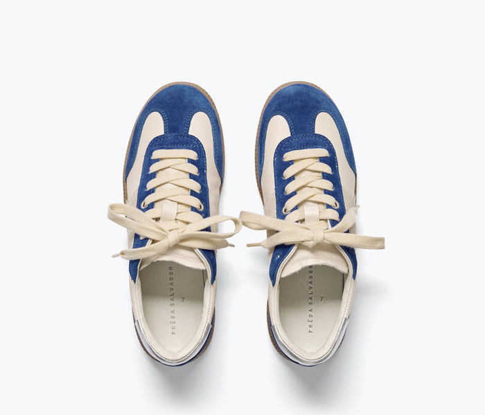 FREDA SALVADOR Jackie sneaker in cobalt suede with white rubber sole and lace-up design, shown from top angle.