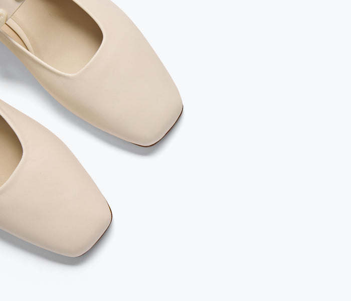 FREDA SALVADOR Jane Mary Jane flat shoe with gold shell details on bone-colored material, showcasing elegant footwear design.