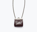 Fredas Salvador Kenzo mini purse necklace featuring a wine-colored crinkle patent bag with a sleek, stylish design.